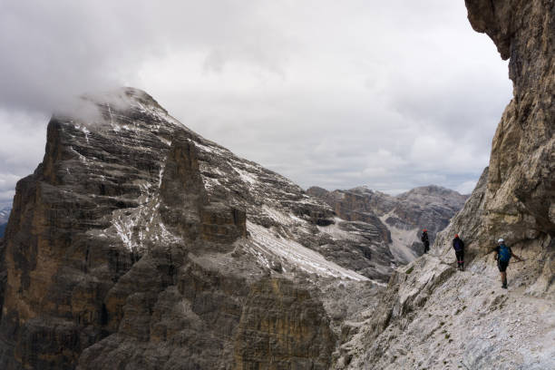 istock three mountain climbers on an exposed ledge in the Italian Dolomites 892142698