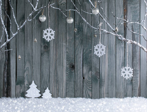 Christmas interior with decorative branches and fir tree on wooden planks background
