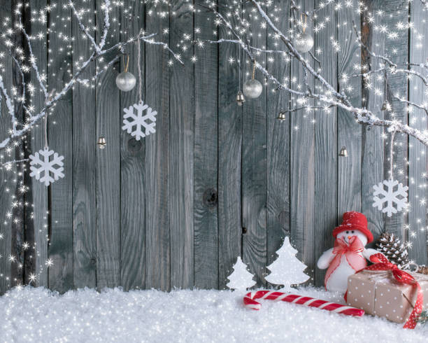 istock Christmas interior with decorative branches, presents and candy canes on wooden planks background 892147790