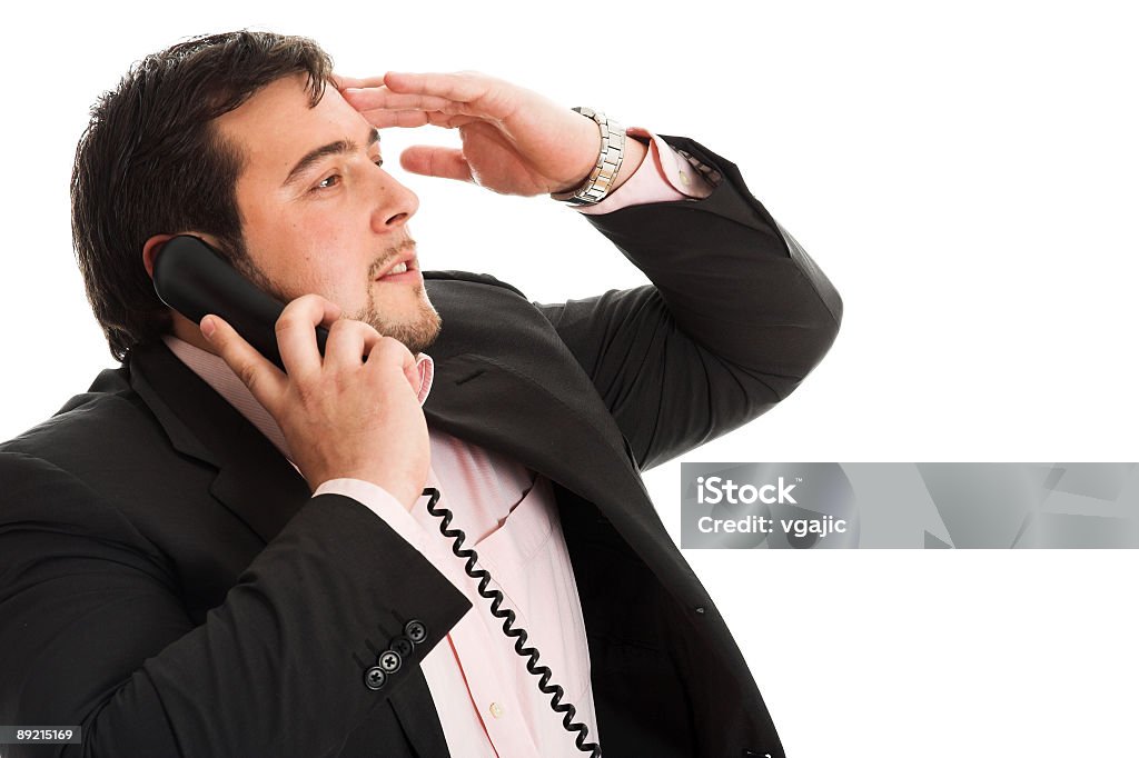 Business troubles Businessman in trouble talking on the phone isolated on white background Adult Stock Photo