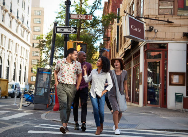 group of friends crossing urban street in new york city - front stoop imagens e fotografias de stock