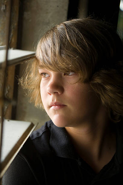 istock Teenage Boy Looking Out Window 89215879