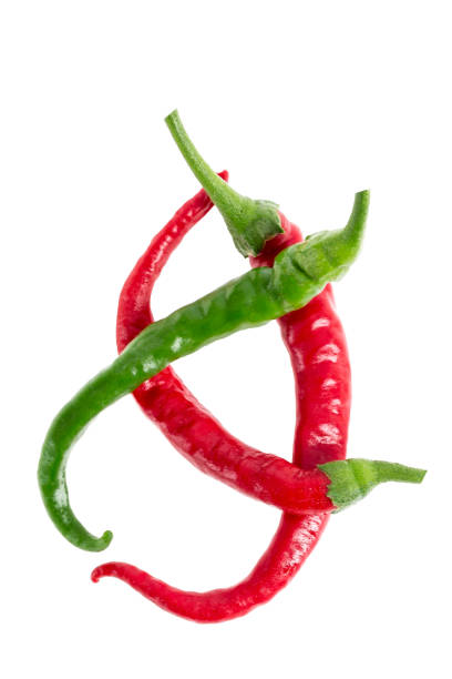 istock Green, cayenne red colored chillies isolated on white background 892159806