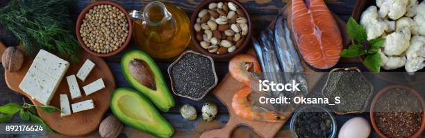 Composition Of Products Containing Unsaturated Fatty Acids Omega 3 Fish Nuts Tofu Avocado Egg Soybeans Flax Pumpkin Seeds Chia Hemp Cauliflower Dill Vegetable Oil Top View Healthy Food Stock Photo - Download Image Now