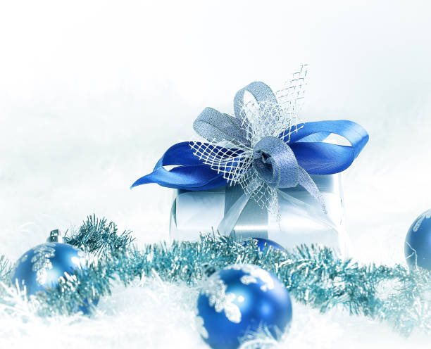 istock Christmas gift and blue Christmas balls on a festive white back 892183048