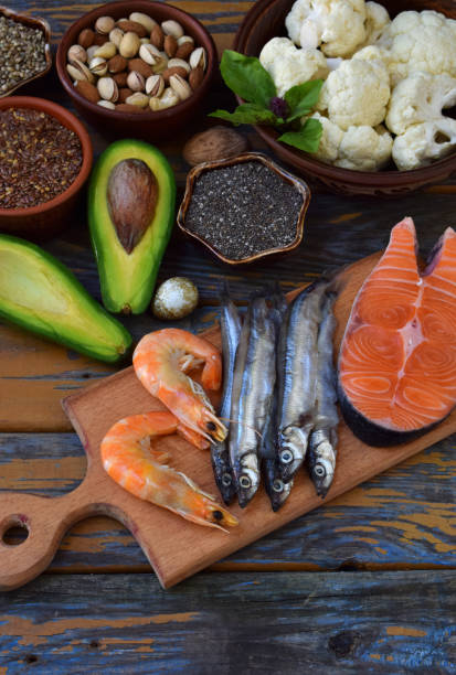 istock Composition of products containing unsaturated fatty acids Omega 3 - fish, nuts, avocado, eggs, soybeans, flax, pumpkin seeds, chia, hemp, cauliflower, dill, vegetable oil. Top view. Healthy food 892183366