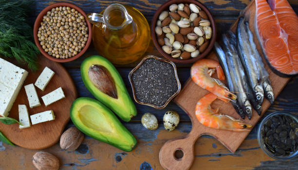 istock Composition of products containing unsaturated fatty acids Omega 3 - fish, nuts, tofu, avocado, eggs, soybeans, pumpkin seeds, chia, hemp, dill, vegetable oil. Top view. Healthy food 892184034