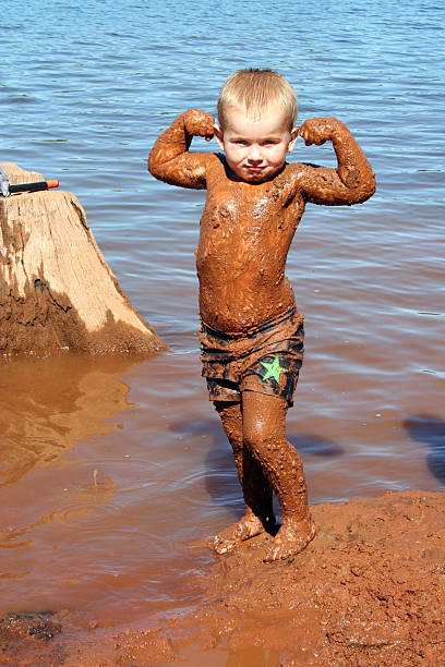 Muddy Boy  people covered in mud stock pictures, royalty-free photos & images