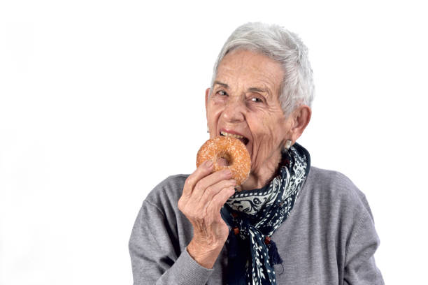 istock senior woman eating 892196842