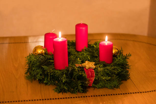 istock Bright red candles on round Advent wreath 892207874