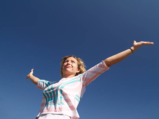 istock Happy young woman under blue sky 89221291