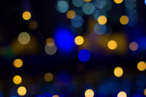 istock yellow and blue bokeh light on black background 892218458