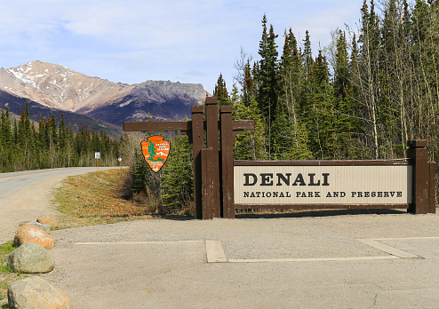 Denali National Park, Alaska: Entrance of the Park with a sign in the front and a road in the back.
