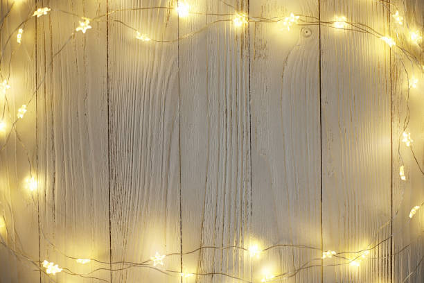 istock Christmas bright garlands on a wooden light background 892238246