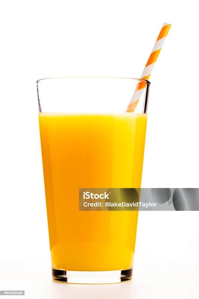 Glass of Orange Juice One glass of orange juice with an orange straw Orange Juice Stock Photo