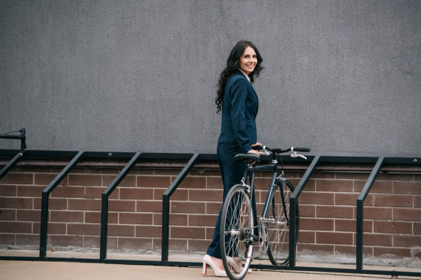 istock businesswoman parking bicycle 892249200