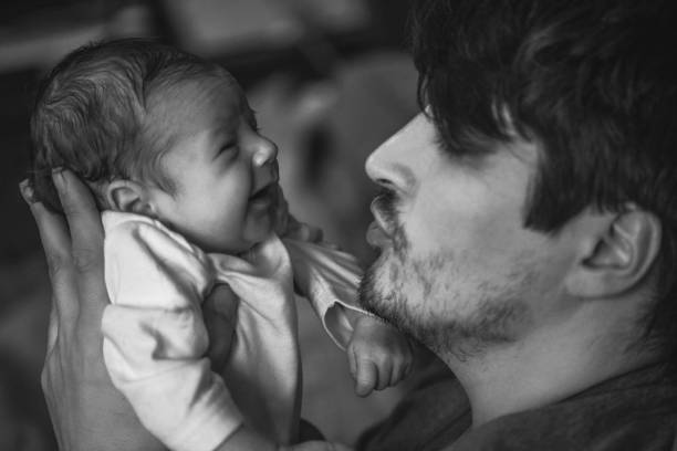 istock Father with newborn baby in B&W 892252474