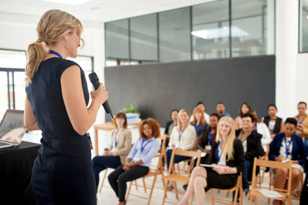 Her presentation leaves an impact on her colleagues Shot of a young businesswoman delivering a presentation at a conference presentation speech stock pictures, royalty-free photos & images