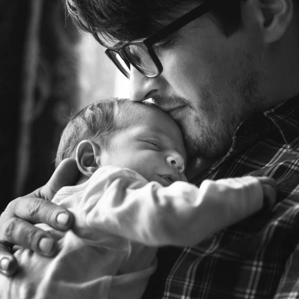 Father with newborn baby in B&W