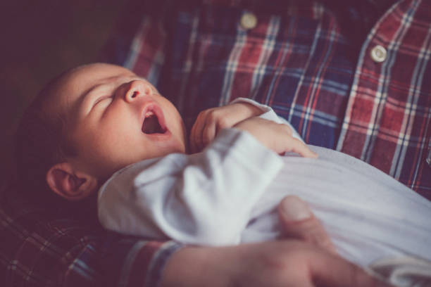 istock Newborn baby yawning 892253472