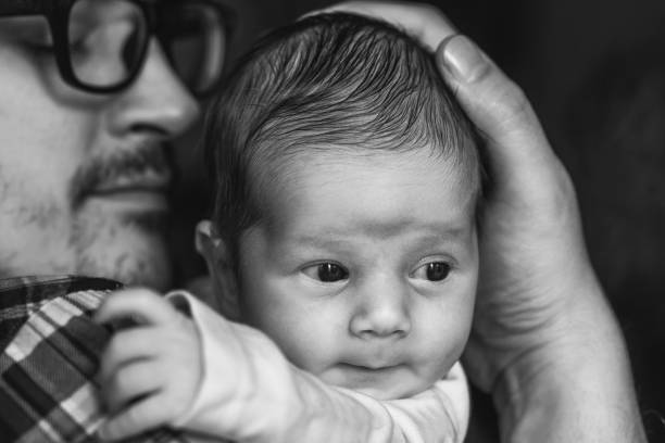istock Father with newborn baby in B&W 892253742