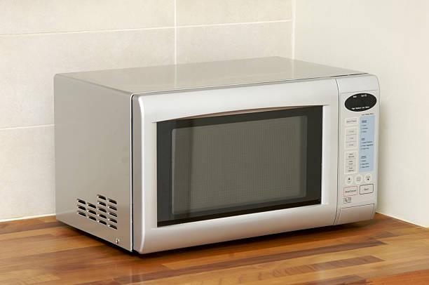 Microwave oven on kitchen worktop  inside microwave stock pictures, royalty-free photos & images