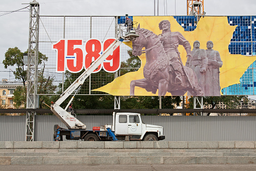 Volgograd, Russia - September 20, 2016: Workers dismantle a festive panel at the Square of the Fallen Fighters in Volgograd. The festive panel depicts the year of foundation of the city and the founders G. Zasekin, R. Olferov, I. Nashchekin.