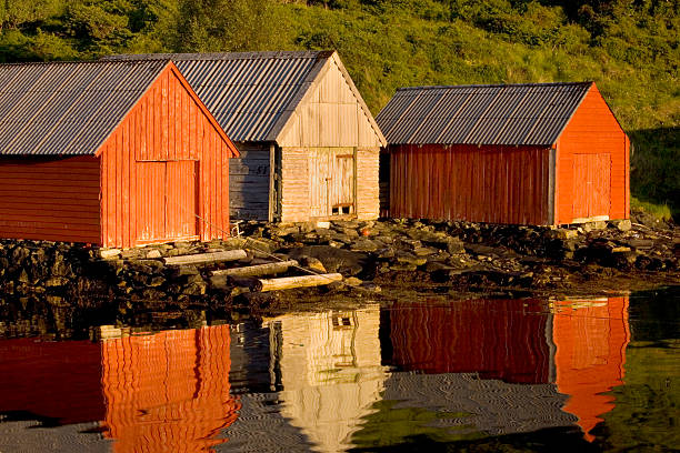 Boathouses with reflection, Bergen area, Norway. stock photo