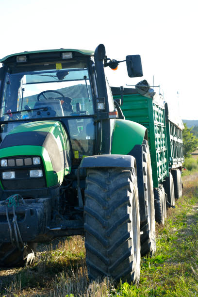 istock combine and tractor duo in the field 892272668