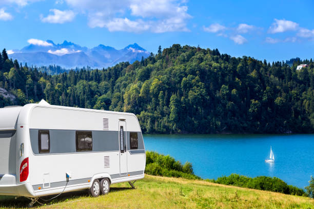 Summer scene with Czorsztyn lake and Tatra Mountains landscape, Poland Summer scene with camper trailer by the Czorsztyn lake and Tatra Mountains landscape, Poland tatra tourists stock pictures, royalty-free photos & images
