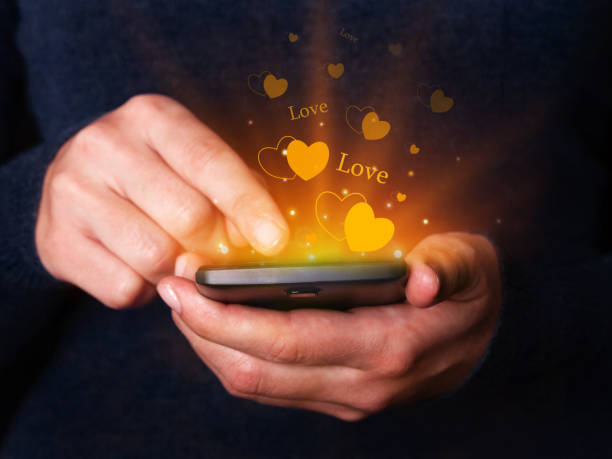 istock Woman hands holding and using smartphone mobile or cell phone for texting or messaging for Valentines Day. 892273106