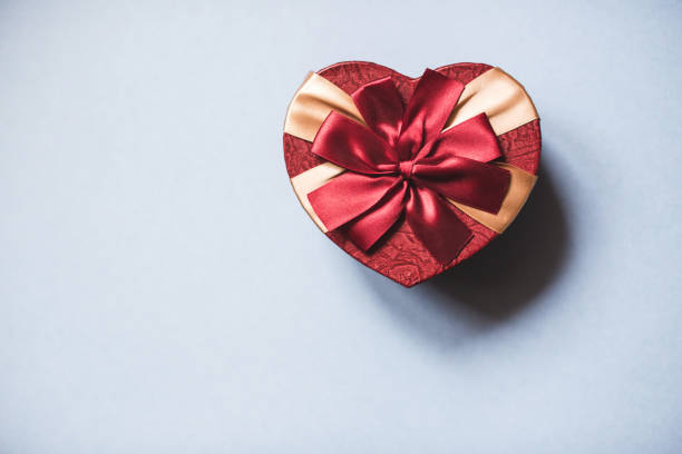 istock Heart shaped gift box on a blue background top view. 892275402