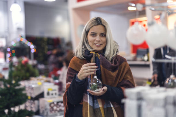 istock Woman buying Christmas decoration 892277566