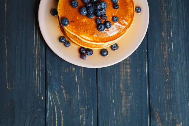 istock Pancakes with honey and blueberries on wooden table 892277990