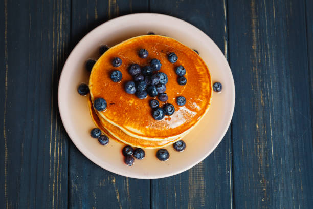 istock Pancakes with honey and blueberries on wooden table 892278204