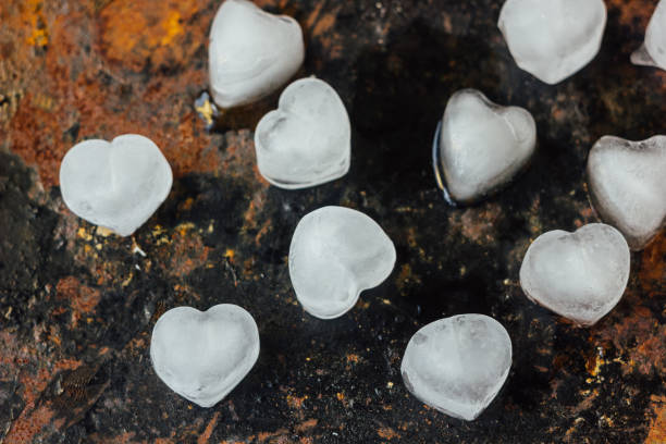 istock ice in form of hearts on black rustic surface. 892280788