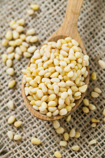 istock pine nuts in a wooden spoon 892282292