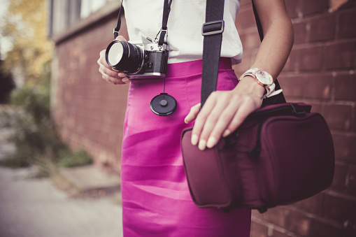 Girl, retro camera and retro fashion, photo bag