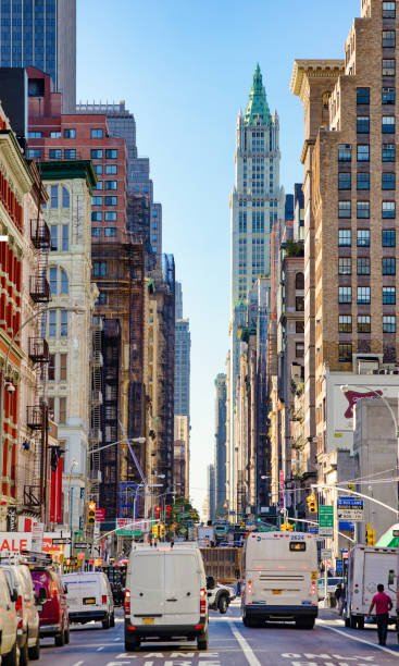 New-York City Manhattan Broadway Avenue Soho Street scene looking South New-York City Manhattan Broadway Avenue in Soho Street scene vertical panorama looking South on a busy Autumn day, with the Woolworth building in the background. soho billboard stock pictures, royalty-free photos & images