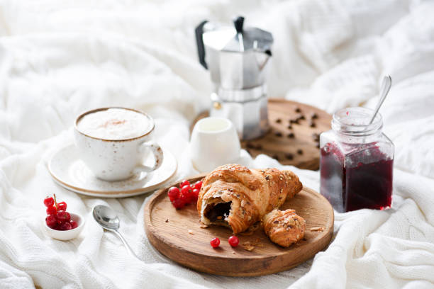 istock Breakfast in bed with croissant, coffee and jam 892288534