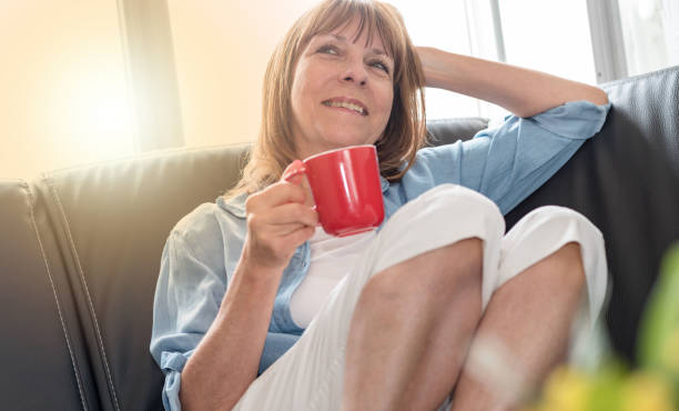 istock Mature woman during coffee break at home, light effect 892293940
