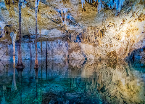 A cenote is a natural pit, or sinkhole, resulting from the collapse of limestone bedrock that exposes groundwater underneath. Especially associated with the Yucatán Peninsula of Mexico, cenotes were sometimes used by the ancient Maya for sacrificial offerings.