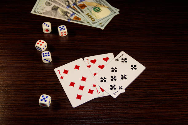 istock Playing cards, dice and dollars on a table 892294950