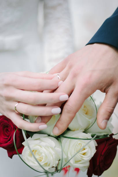 istock Bride put the wedding ring to a groom finger. 892299562