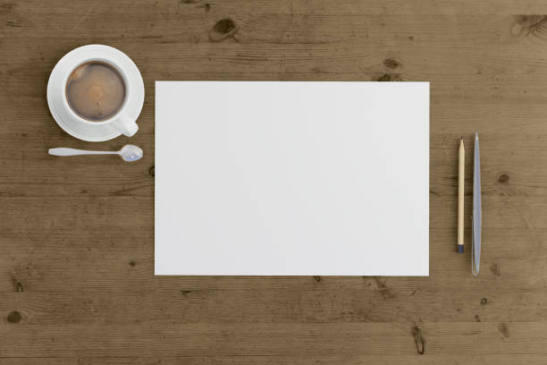 istock Knolling view, white blank paper on a desk template 892300906