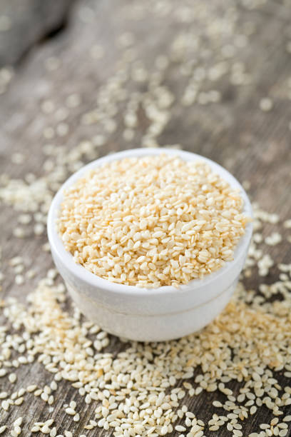 istock sesame seeds on wooden surface 892304220