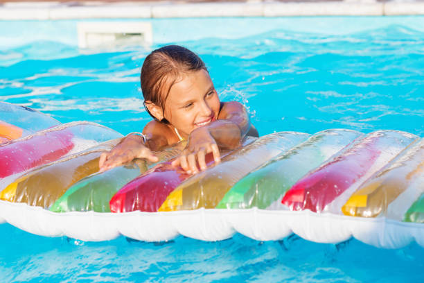 istock Little children playing and having fun in swimming pool 892313002