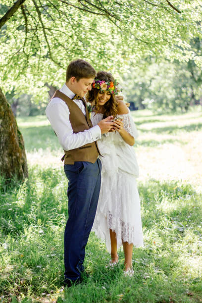 Wedding couple smiling while looking to the smartphone