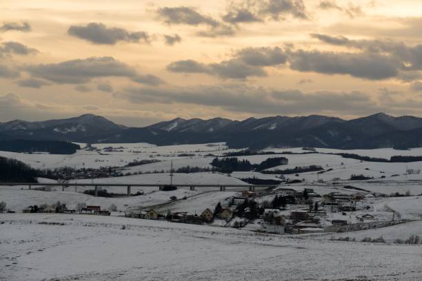 istock Sunset on meadow with snow during winter. Slovakia 892318498