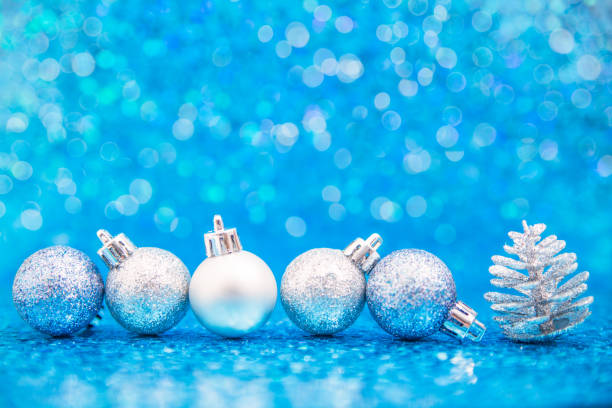 istock Line of blue and silver ornaments with pine cone 892323452